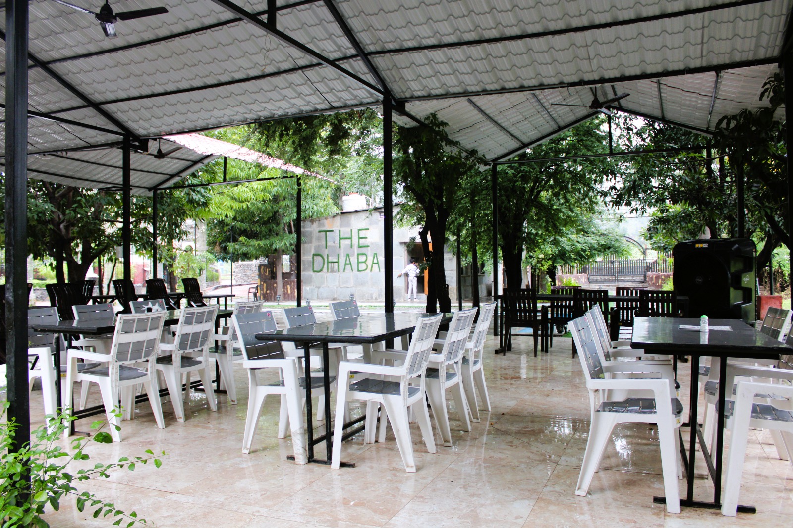 The Dhaba open-air restaurant seating among trees