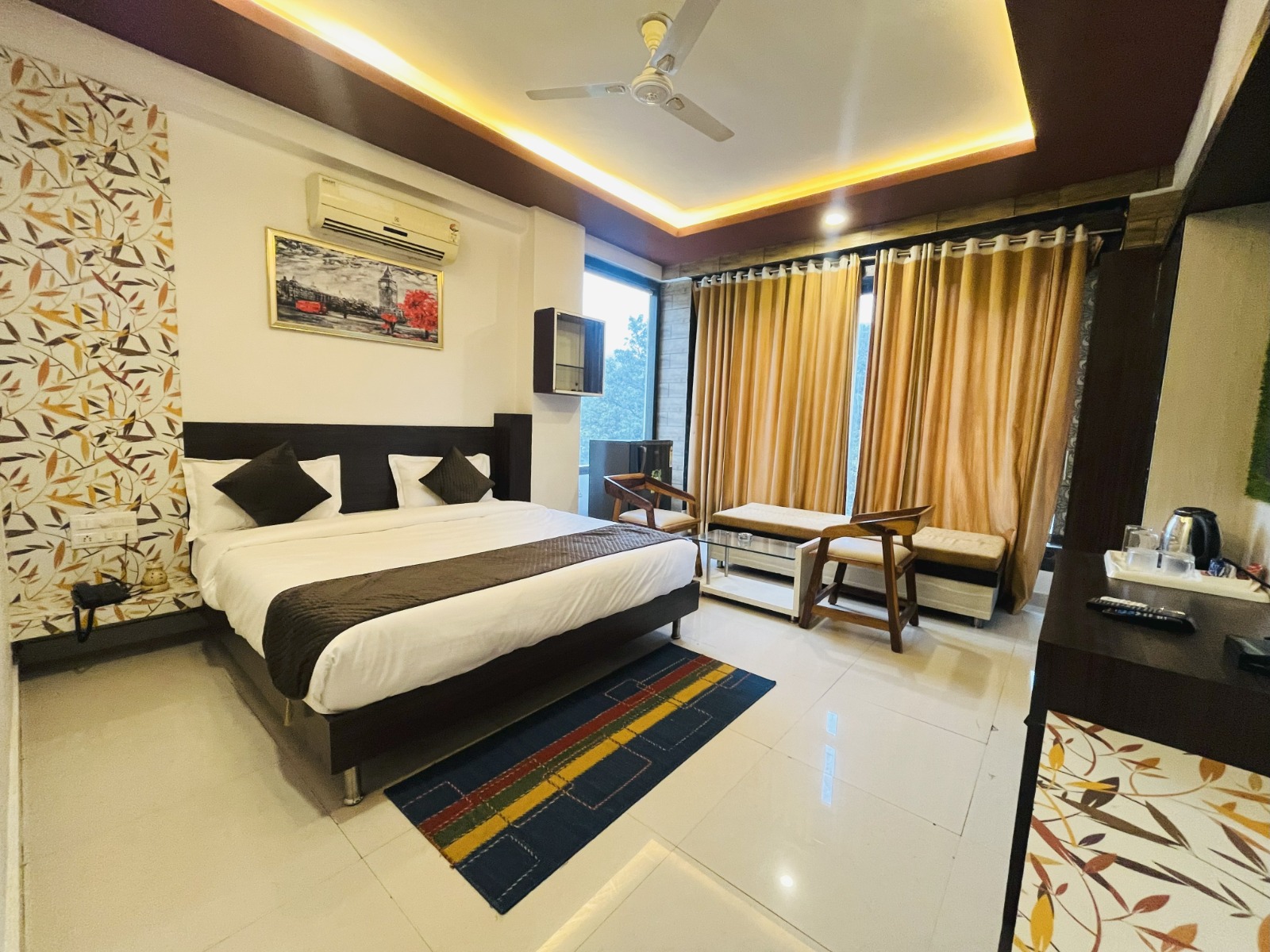 Balcony suite with gold curtains and seating